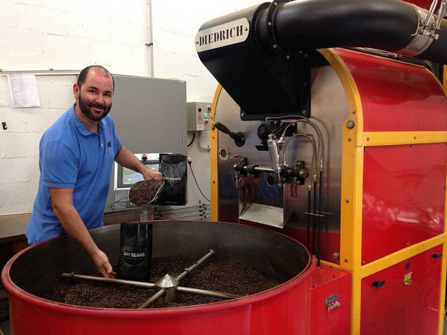 James Axisa packing a bag of Espresso Master coffee beans. 