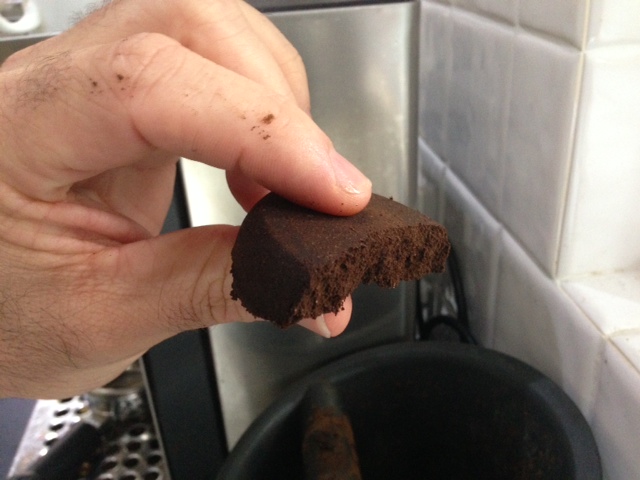 A uniformly dry coffee puck after extraction - snapped in half.